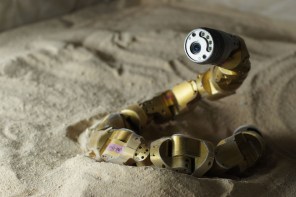 A snake robot built by a team at Carnegie Mellon incorporates the physics of snake movement to travel across sandy slopes.